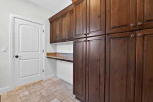 Extensive dark wood cabinetry featuring brushed nickel hardware