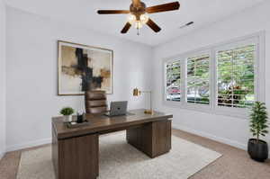 Office space featuring white walls and a carpeted floor