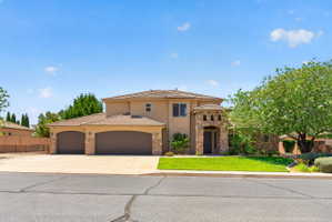 Stucco exterior with stone accents and a tile roof