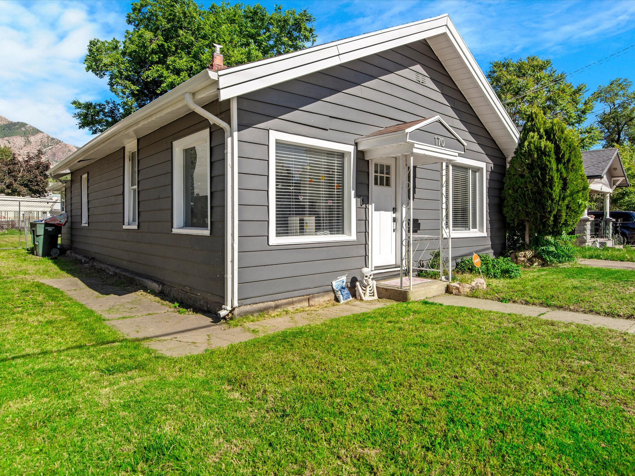 Residential property with dark gray horizontal siding and white trim
