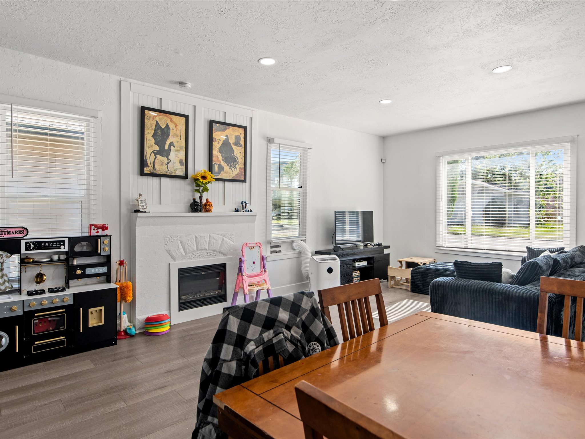 Living area featuring a prominent fireplace with a decorative mantel and board-and-batten accent wall