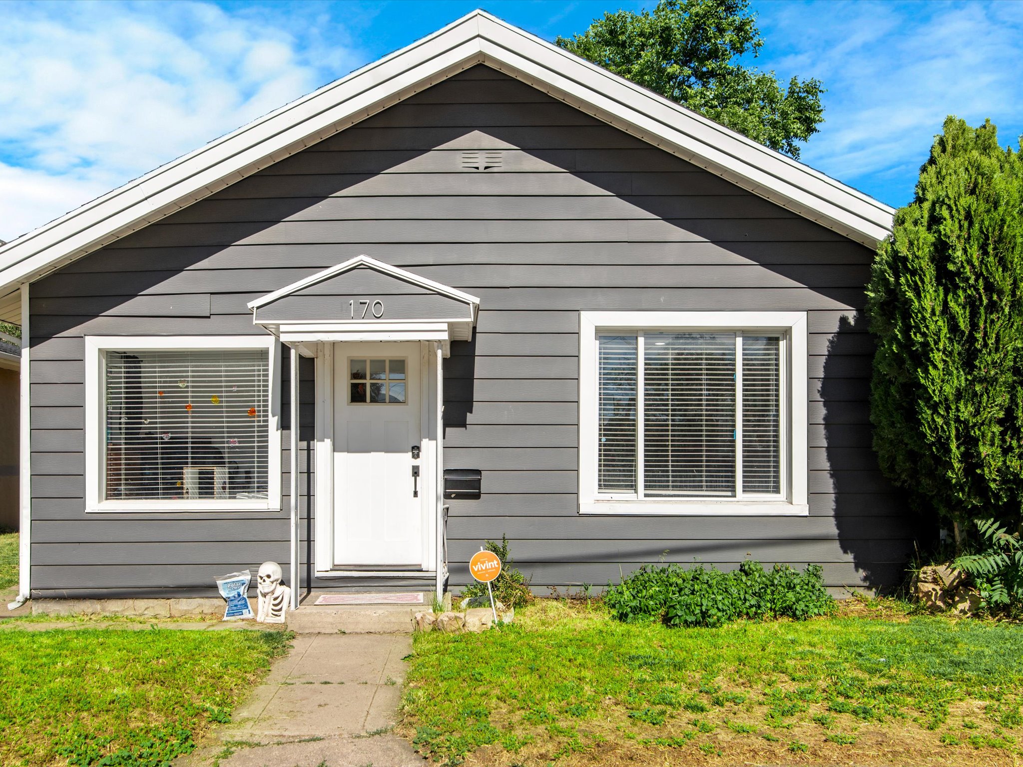 Single-story residence featuring dark gray horizontal siding and contrasting white trim