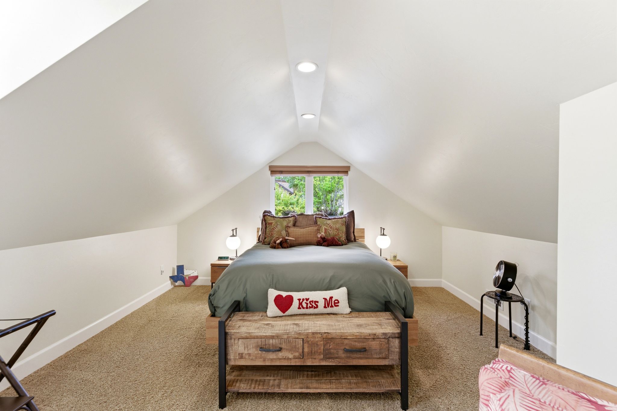 Attic room featuring vaulted ceilings and recessed lighting