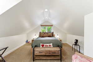 Attic room featuring vaulted ceilings and recessed lighting