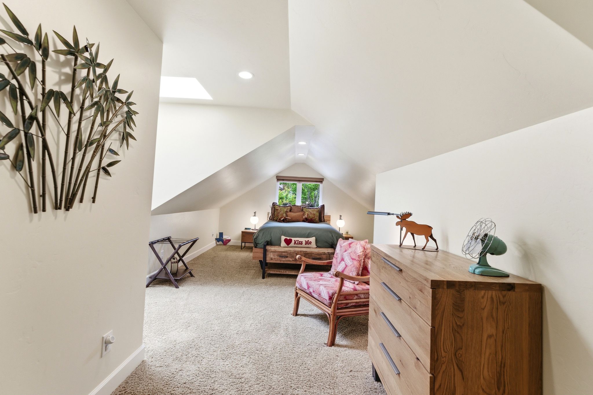 Carpeted bedroom with a vaulted ceiling, recessed lighting, and a skylight