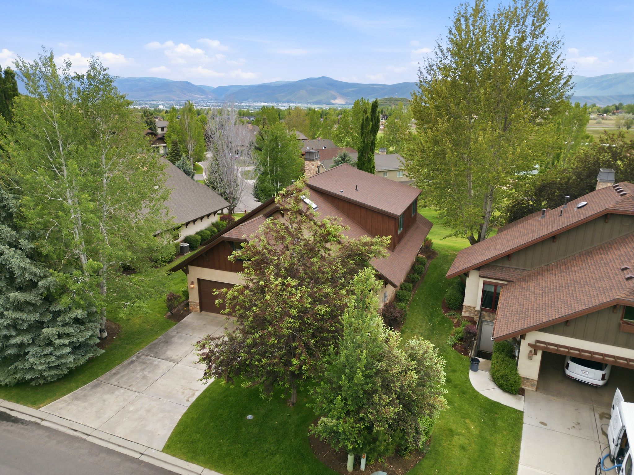 Residential property featuring a brown shingle roof and a two-car garage