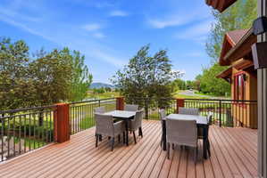 Expansive outdoor deck featuring wood-finish composite decking and dark metal railings