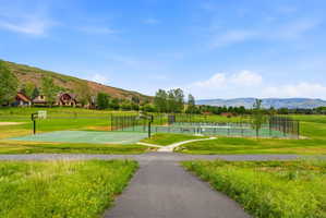 Outdoor recreational area featuring multiple sports courts, including a basketball court and tennis courts, surrounded by expansive green spacesAerial views of Burgi Hill Park adjacent to Valais