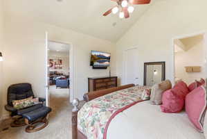 Vaulted ceiling bedroom with a ceiling fan, recessed lighting, and carpet flooring
