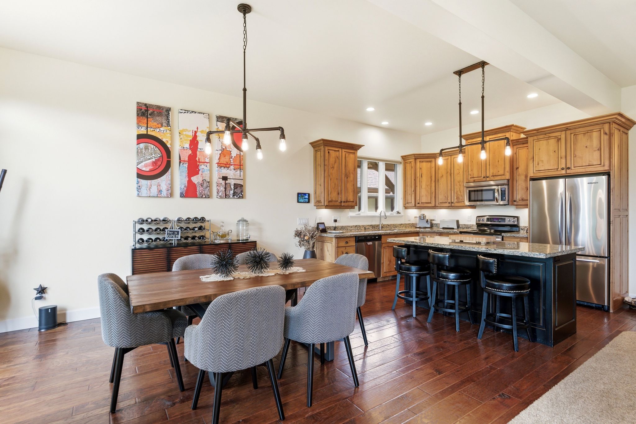 Open-concept kitchen and dining area featuring wood-finish flooring