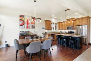 Open-concept kitchen and dining area featuring wood-finish flooring