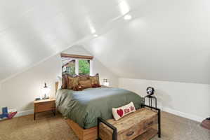 Gabled ceiling room featuring a window with wood-finish blinds, recessed lighting, and soft carpet flooring