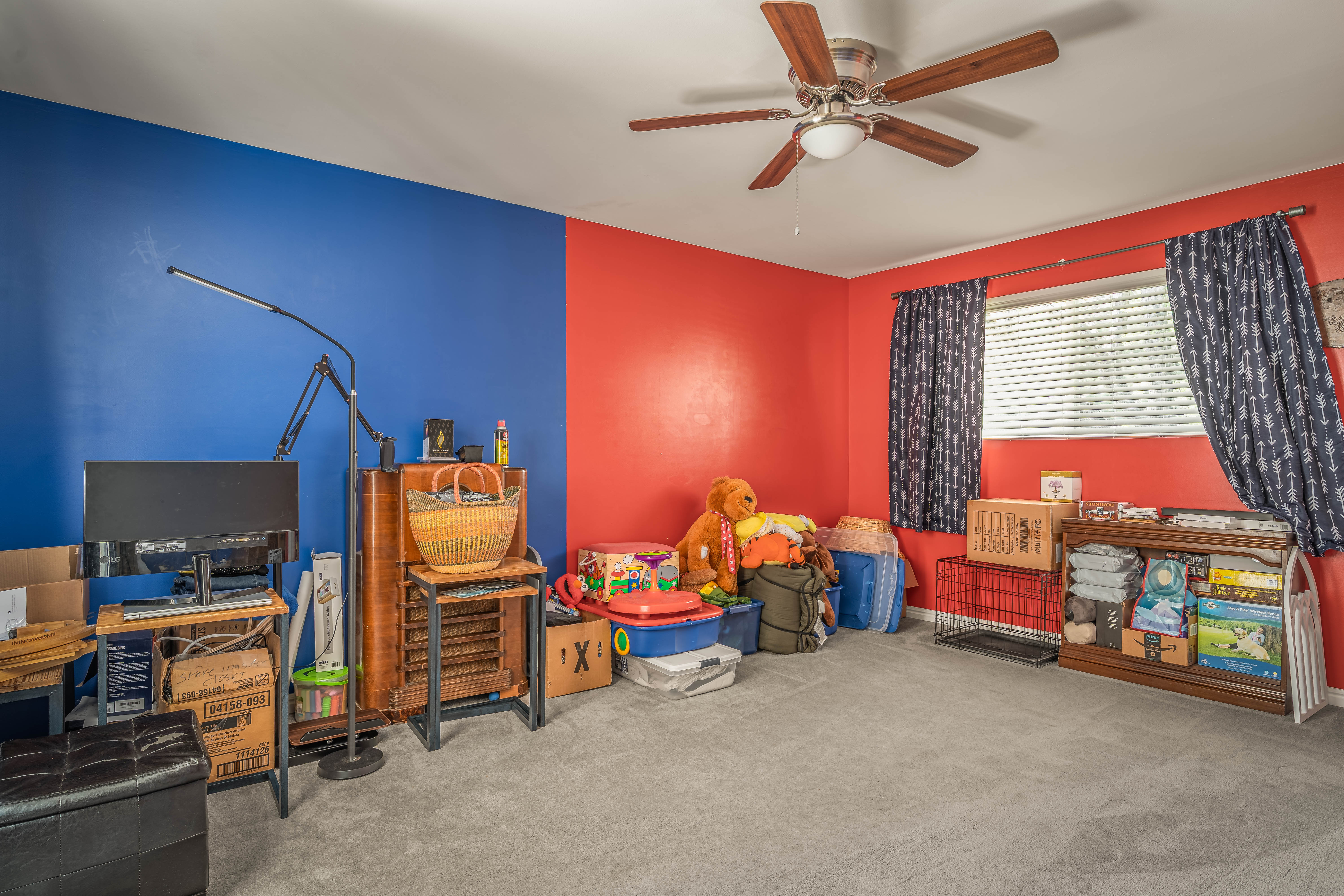 Room featuring dual-toned walls, ceiling fan with integrated lighting, window with horizontal blinds, and carpeting