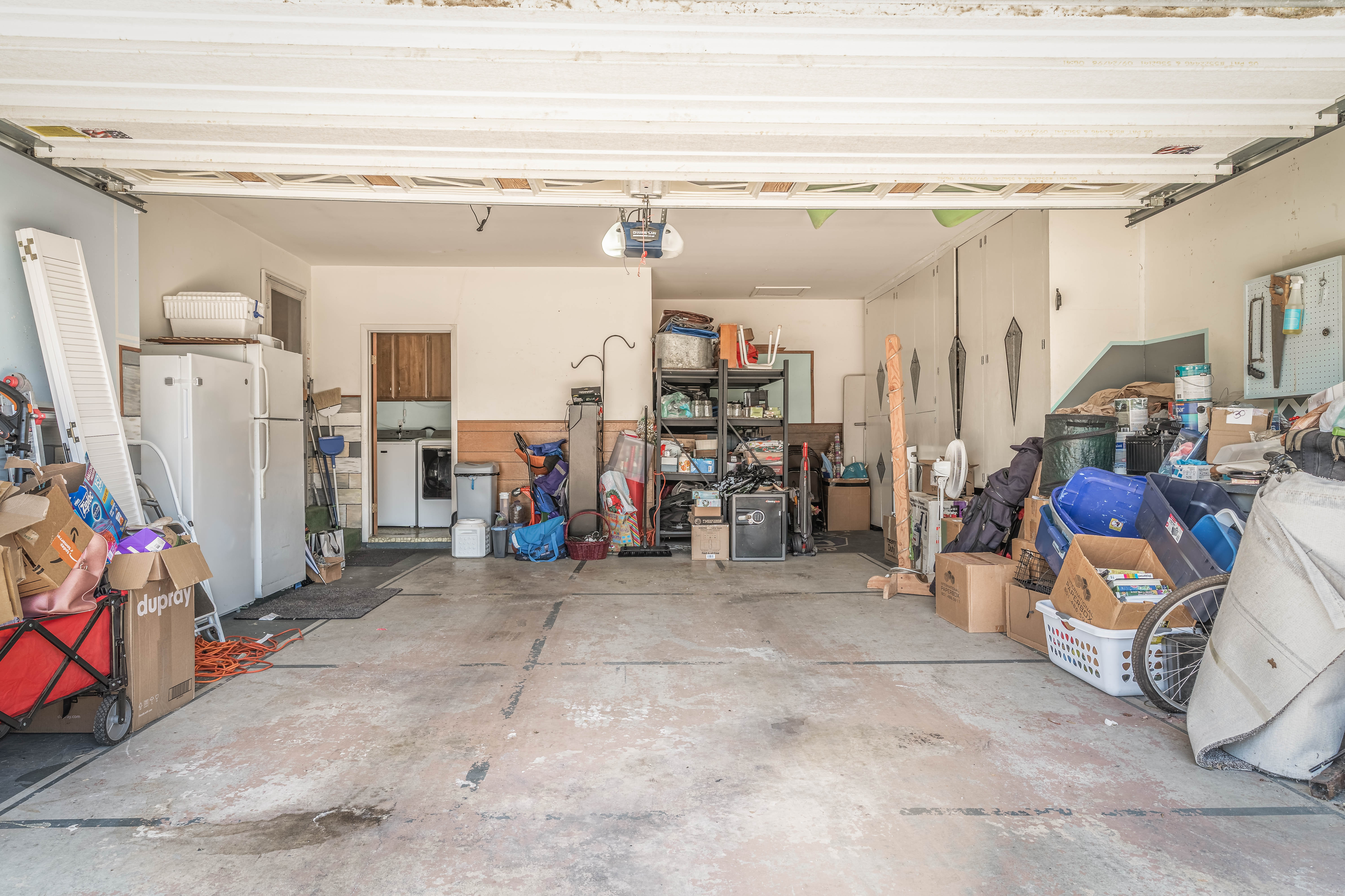 Spacious garage featuring concrete flooring and exposed ceiling joists