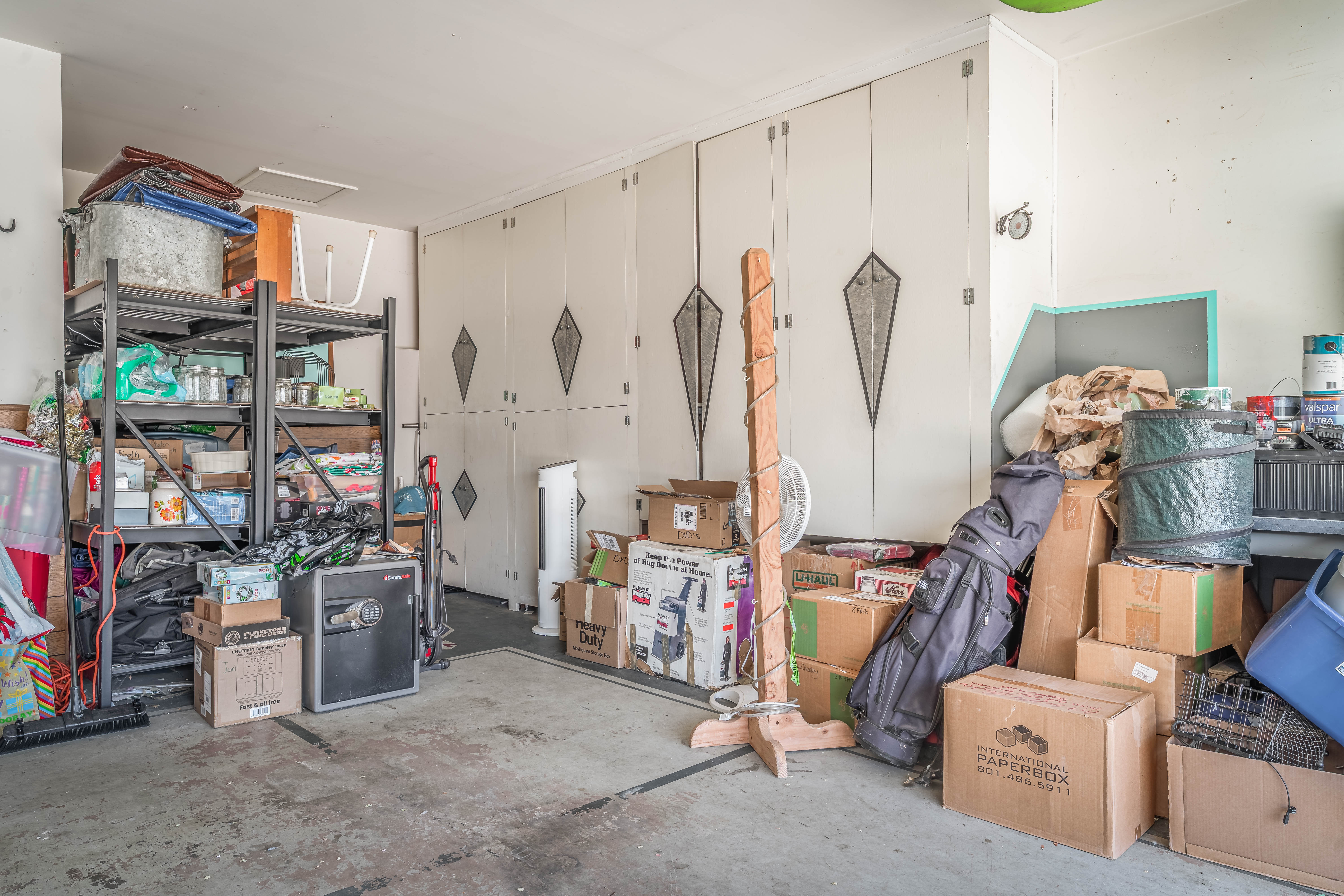 Garage space with built-in cabinetry featuring decorative panels