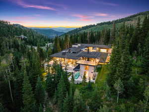 Contemporary multi-level residence with extensive glass facades, multiple balconies, and a flat roofline