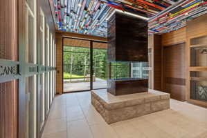 Central freestanding fireplace with a stone base and dark wood-finish surround