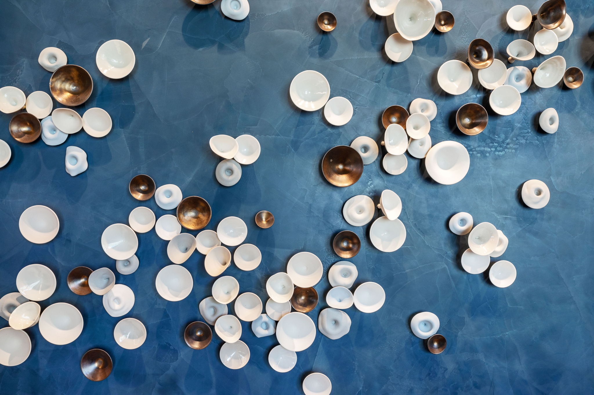 Blue-toned accent wall featuring a dimensional art installation