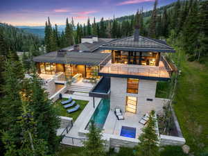 Contemporary residence featuring a multi-level design with a metal roof and extensive glass