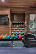 Bowling alley featuring a Brunswick ball return system and wood-paneled walls