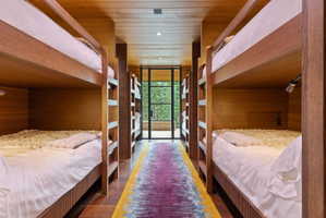 Bunk room featuring built-in wooden bunk beds, recessed lighting, and individual reading lights