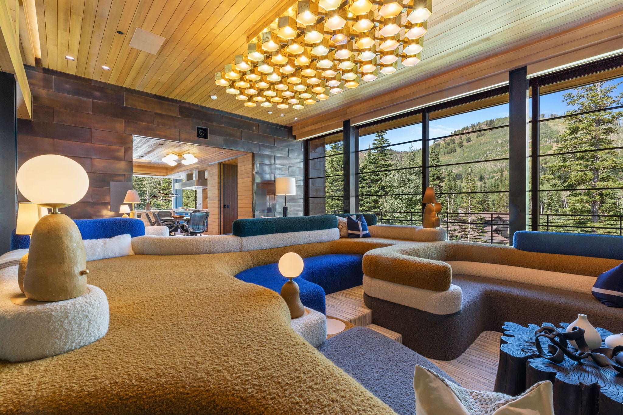 Expansive living area featuring a wood-panel ceiling and an ornate rectangular light fixture