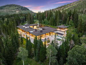 Contemporary mountain residence featuring a multi-level design with extensive outdoor living spaces