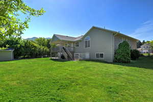 Expansive green lawn with a two-story residence featuring siding and brick accents
