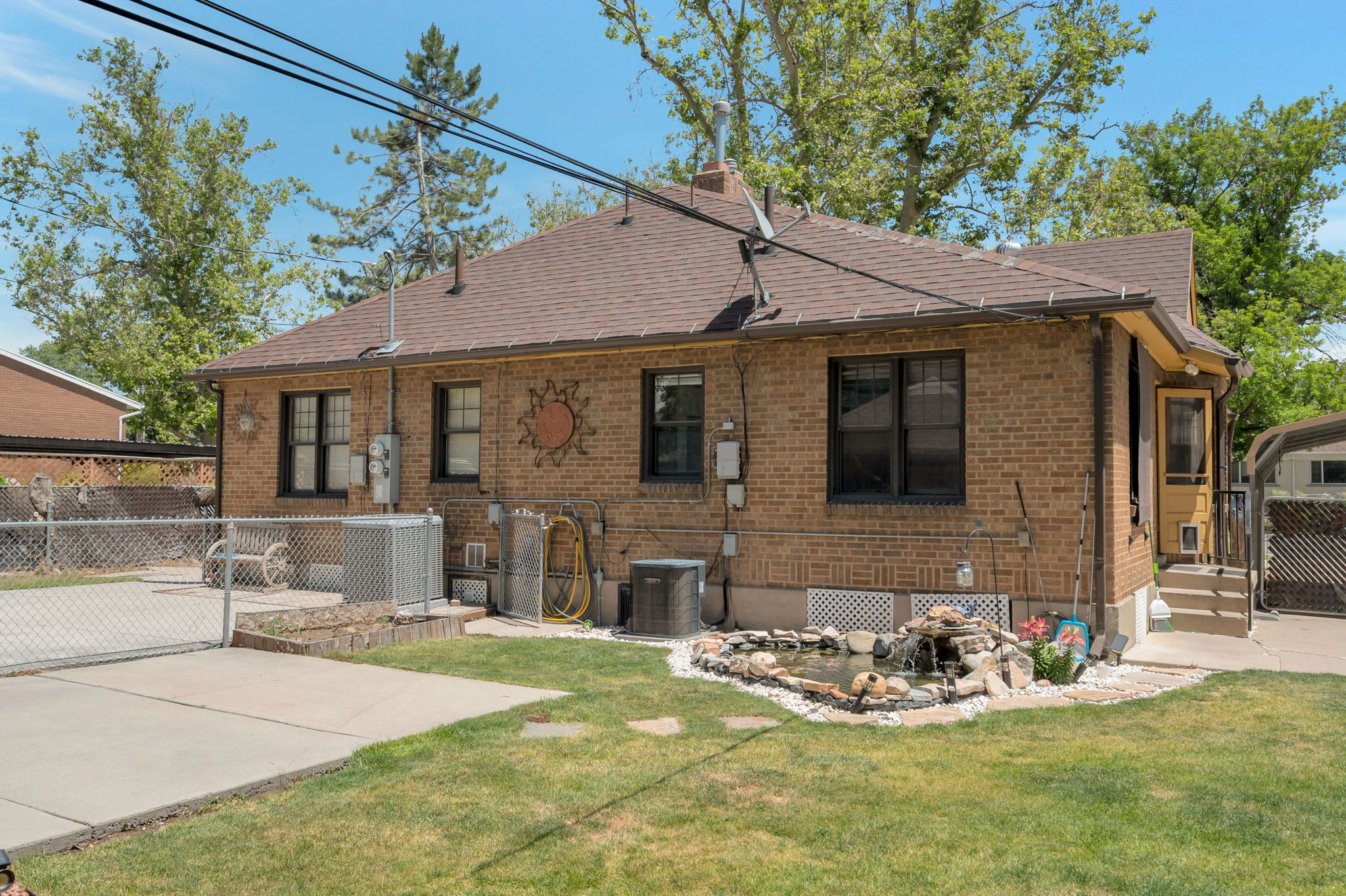 Brick exterior with a brown shingled roof and dark-framed windows