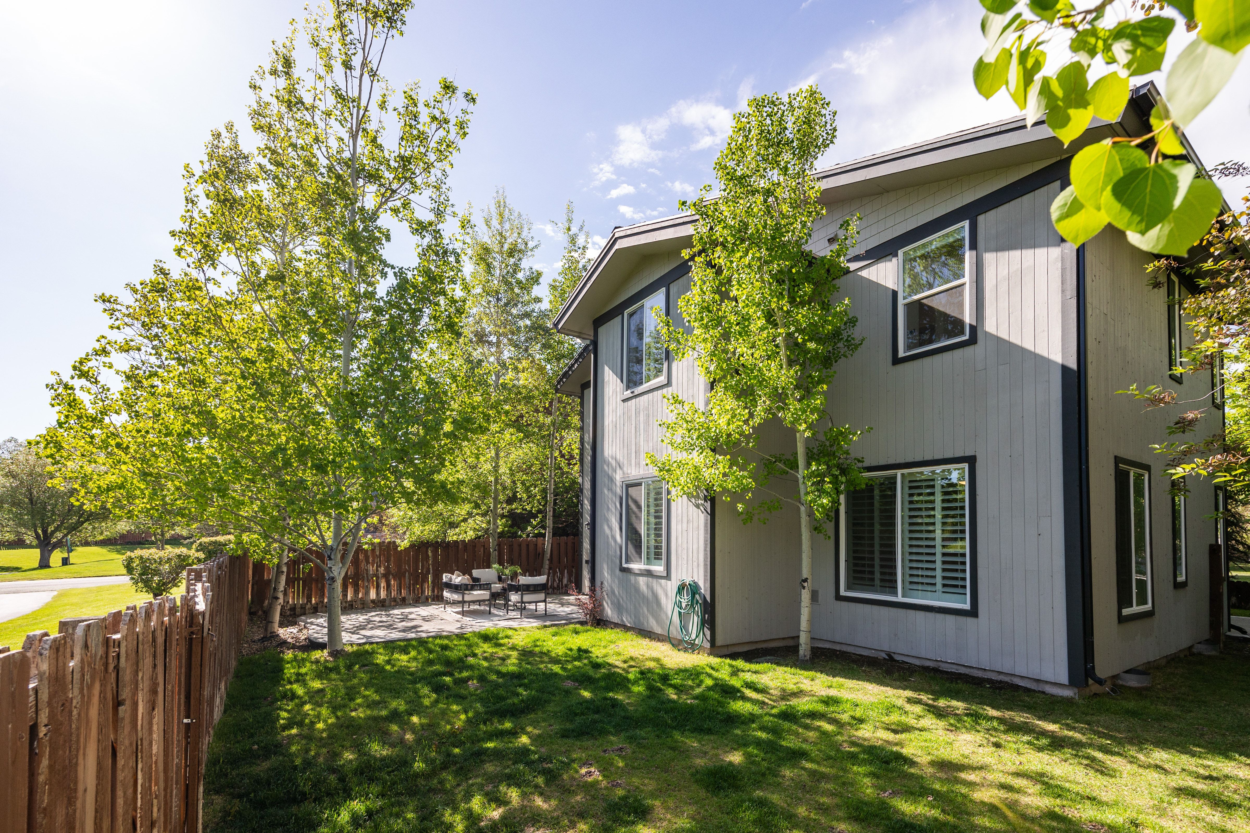 Two-story exterior with light gray siding and dark trim