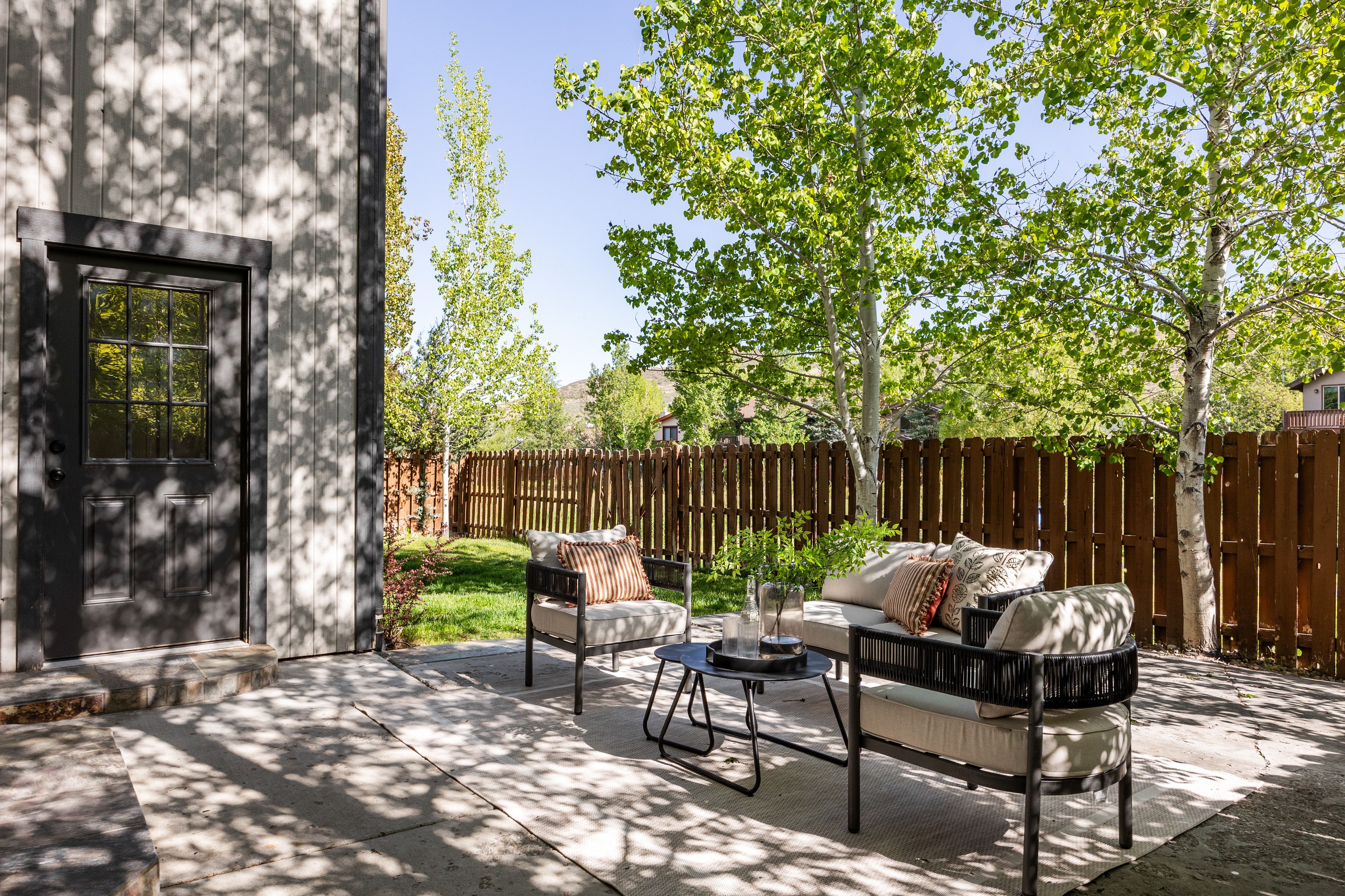 Expansive concrete patio with board and batten siding exterior