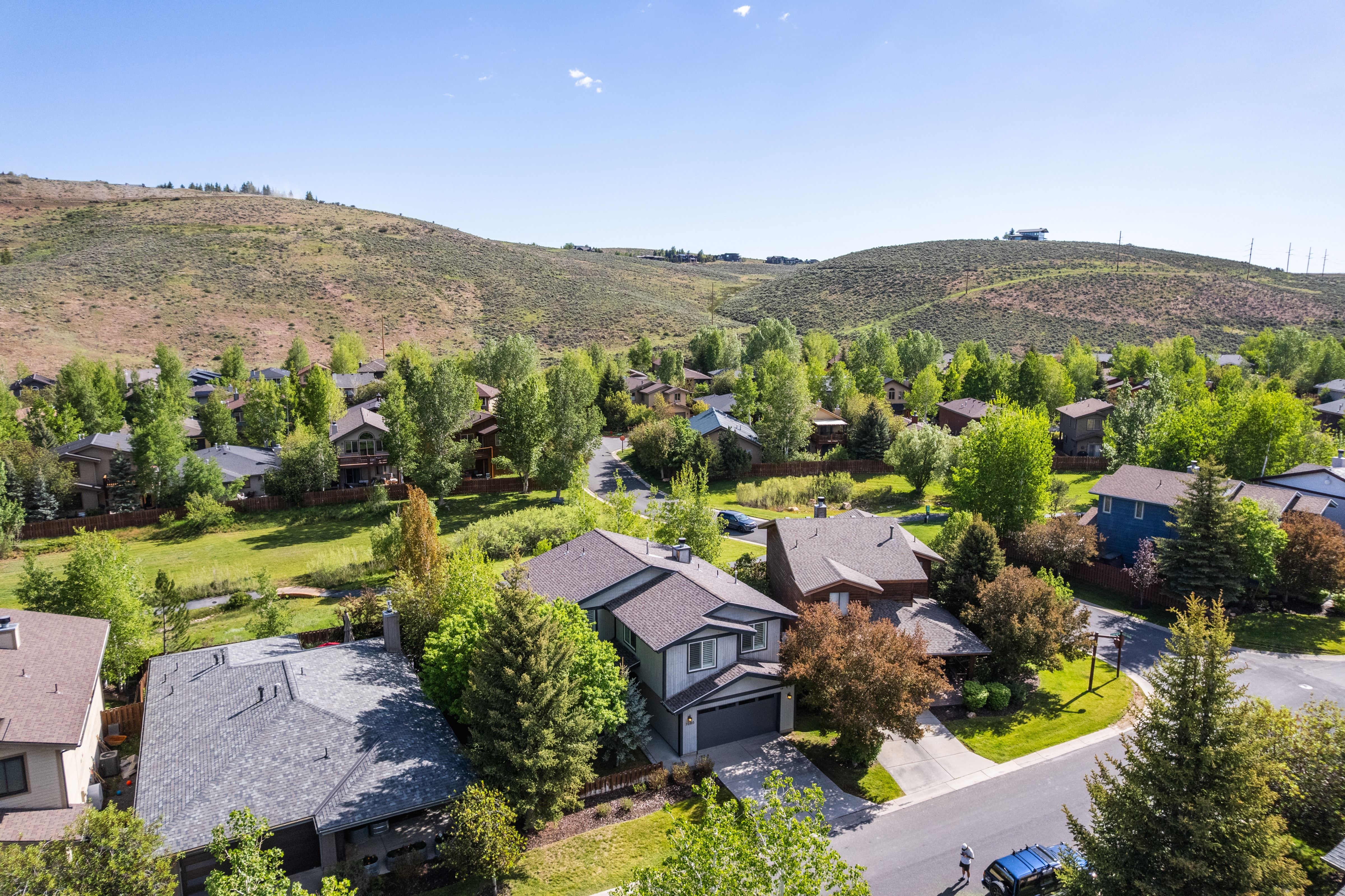 Aerial perspective showcasing a residential community nestled against a mountainous backdrop