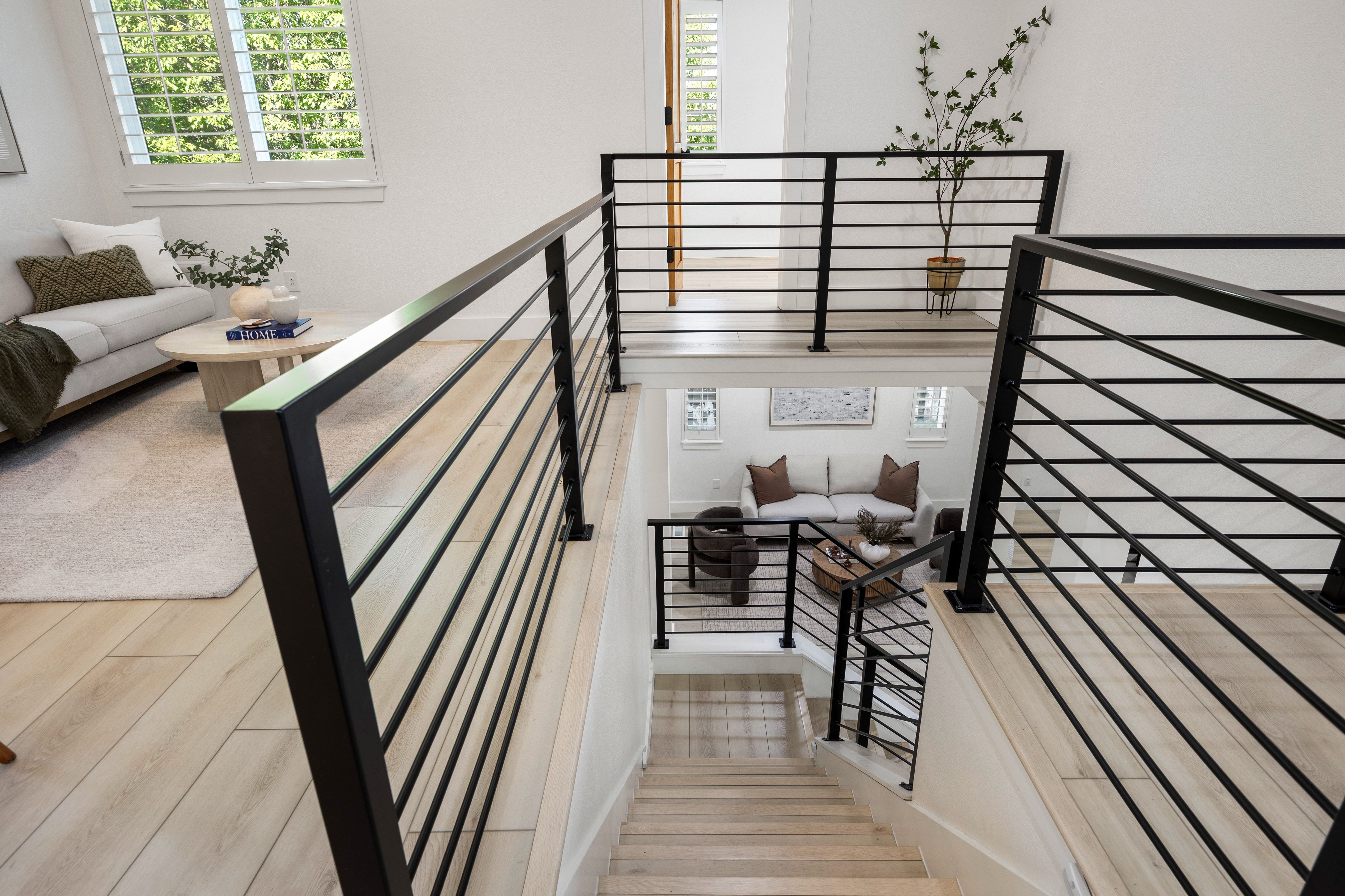 Open-concept interior featuring light wood-finish flooring and a multi-level layout