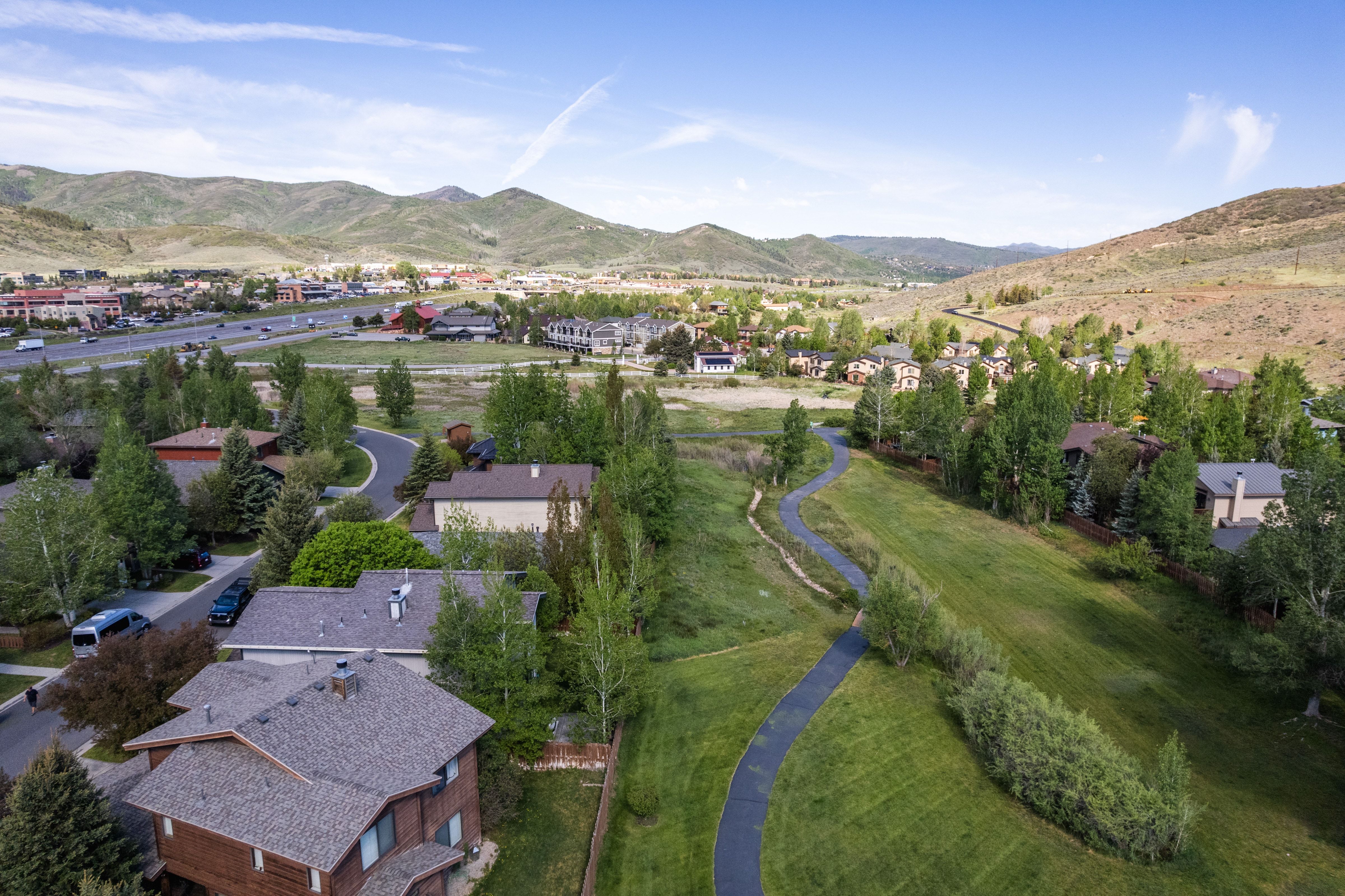Scenic valley setting with distant mountains and established residential areas
