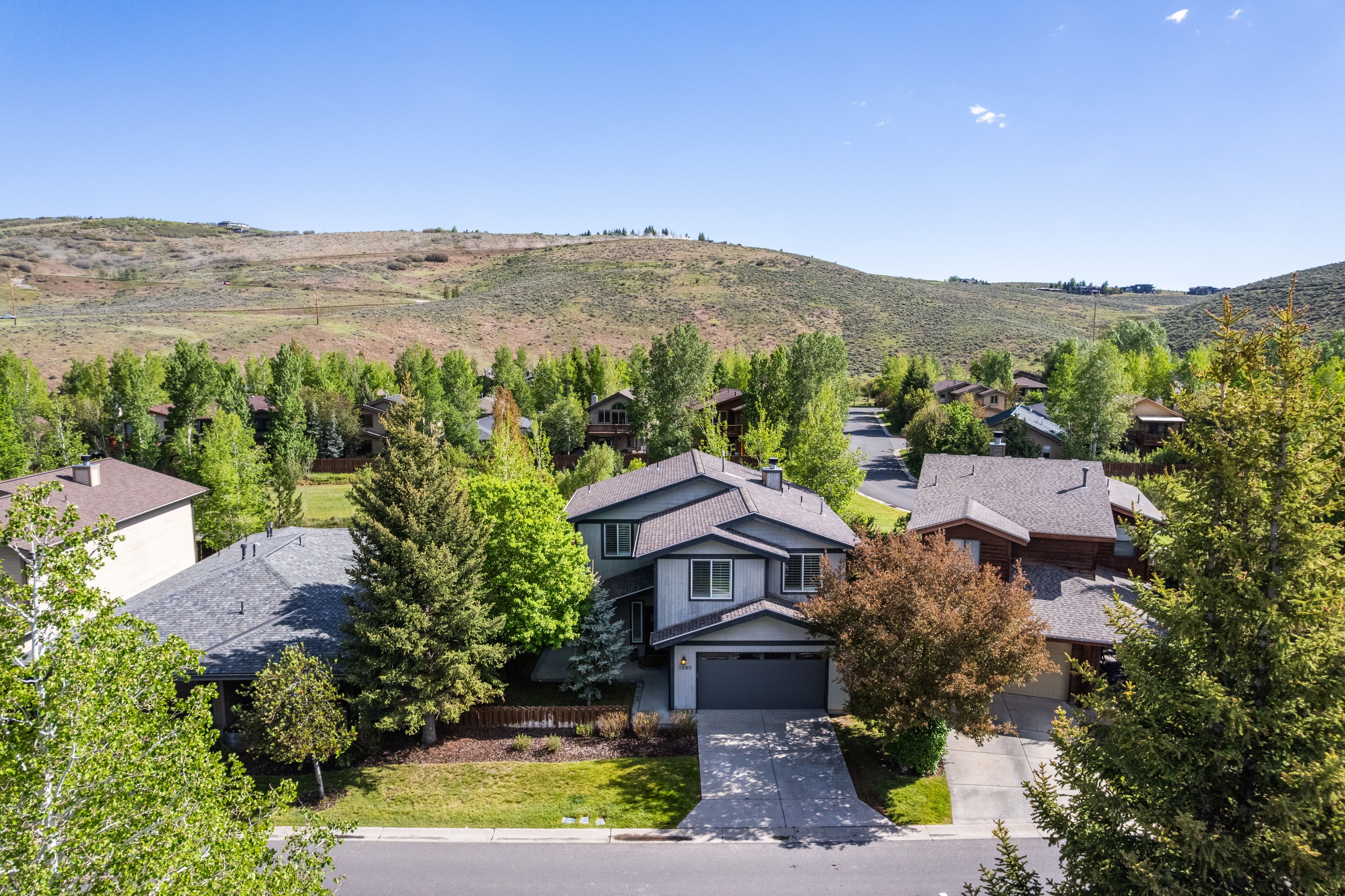 Two-story residence featuring a two-car garage and a paved driveway