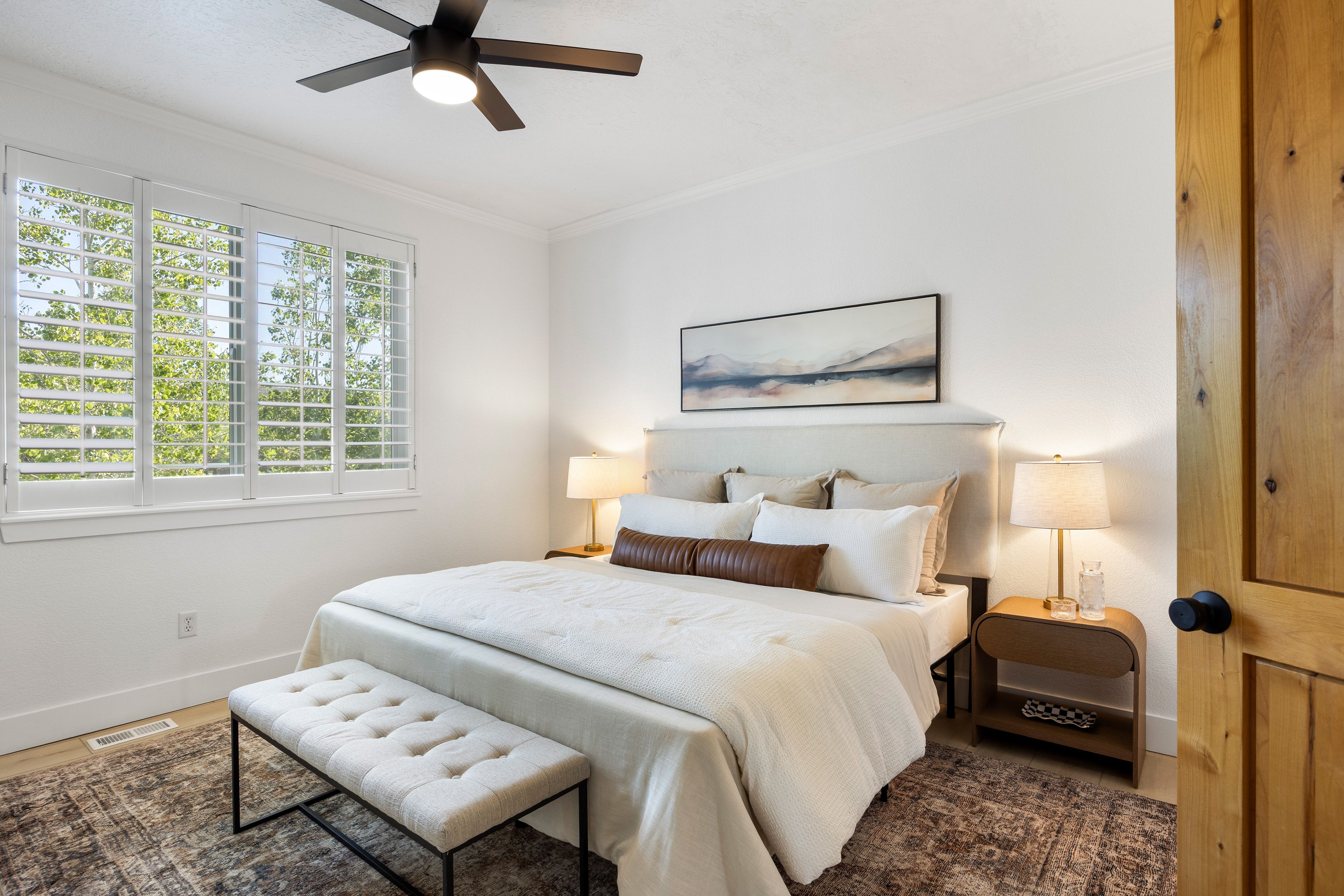 Well-lit interior space featuring white walls and crown molding