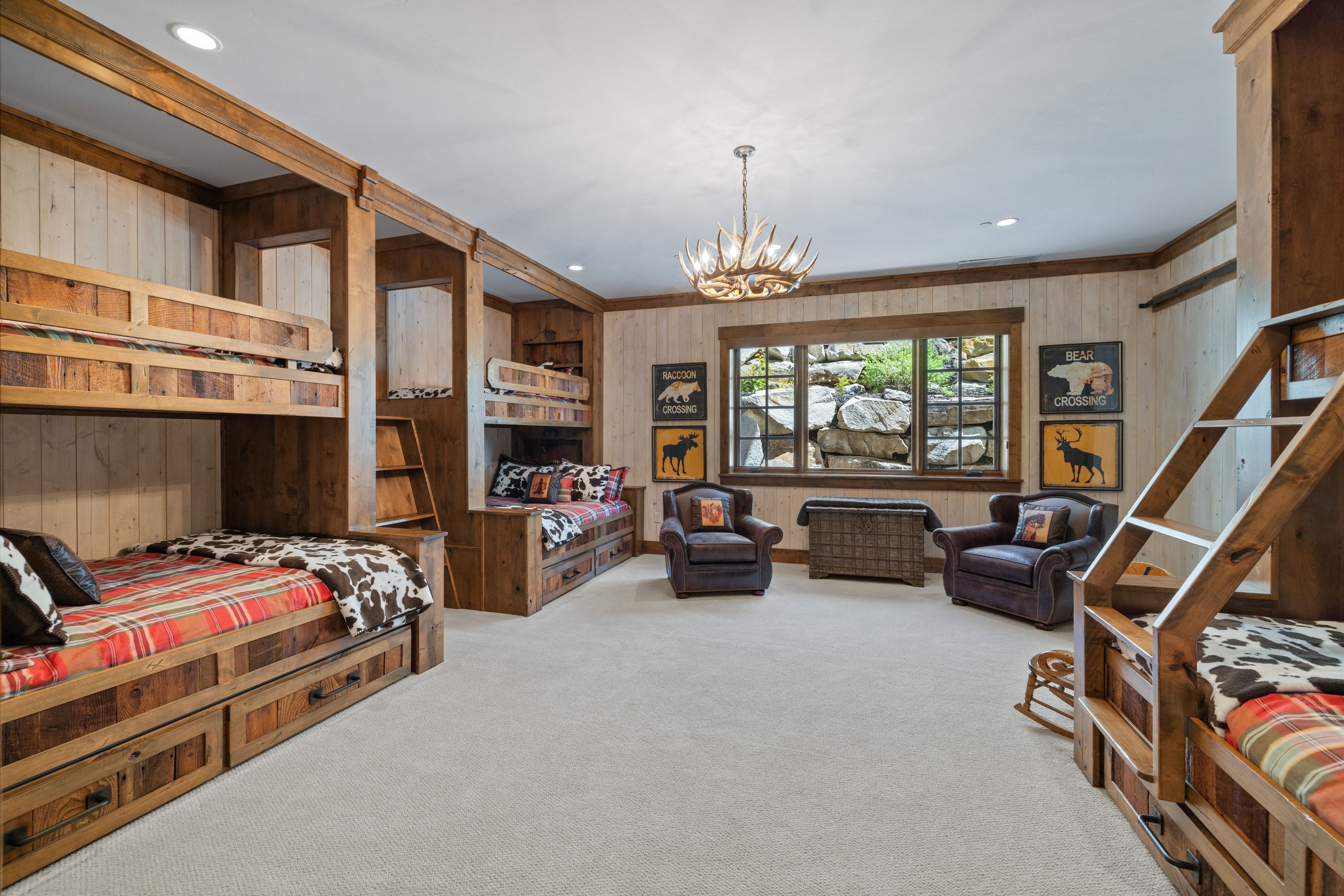 Spacious room featuring multiple built-in bunk beds with integrated storage drawers