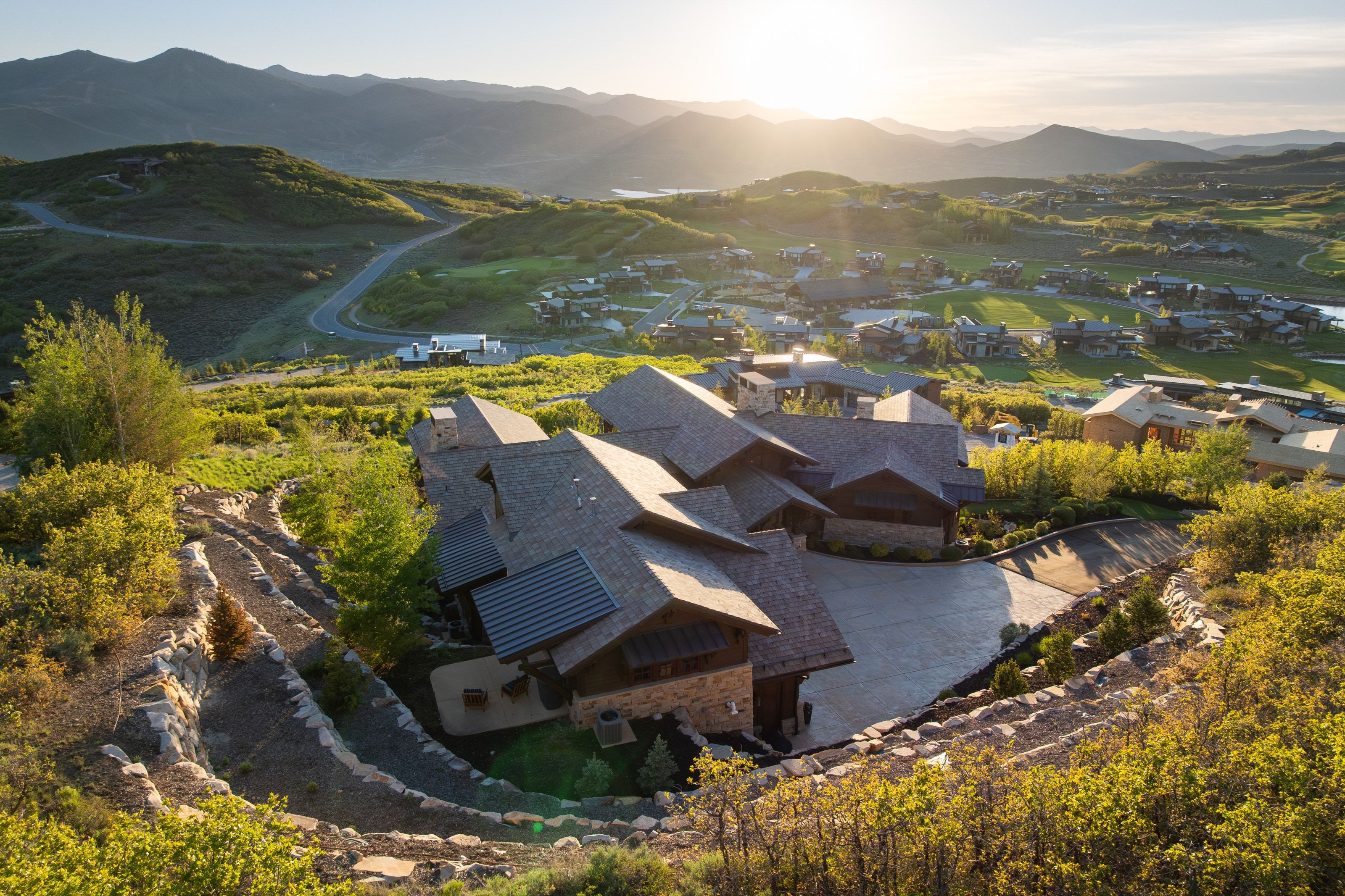Mountain modern residence featuring multiple gables and a stone facade