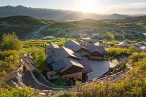 Mountain modern residence featuring multiple gables and a stone facade