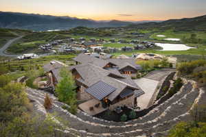Stone and timber residence with multiple gables and a private driveway