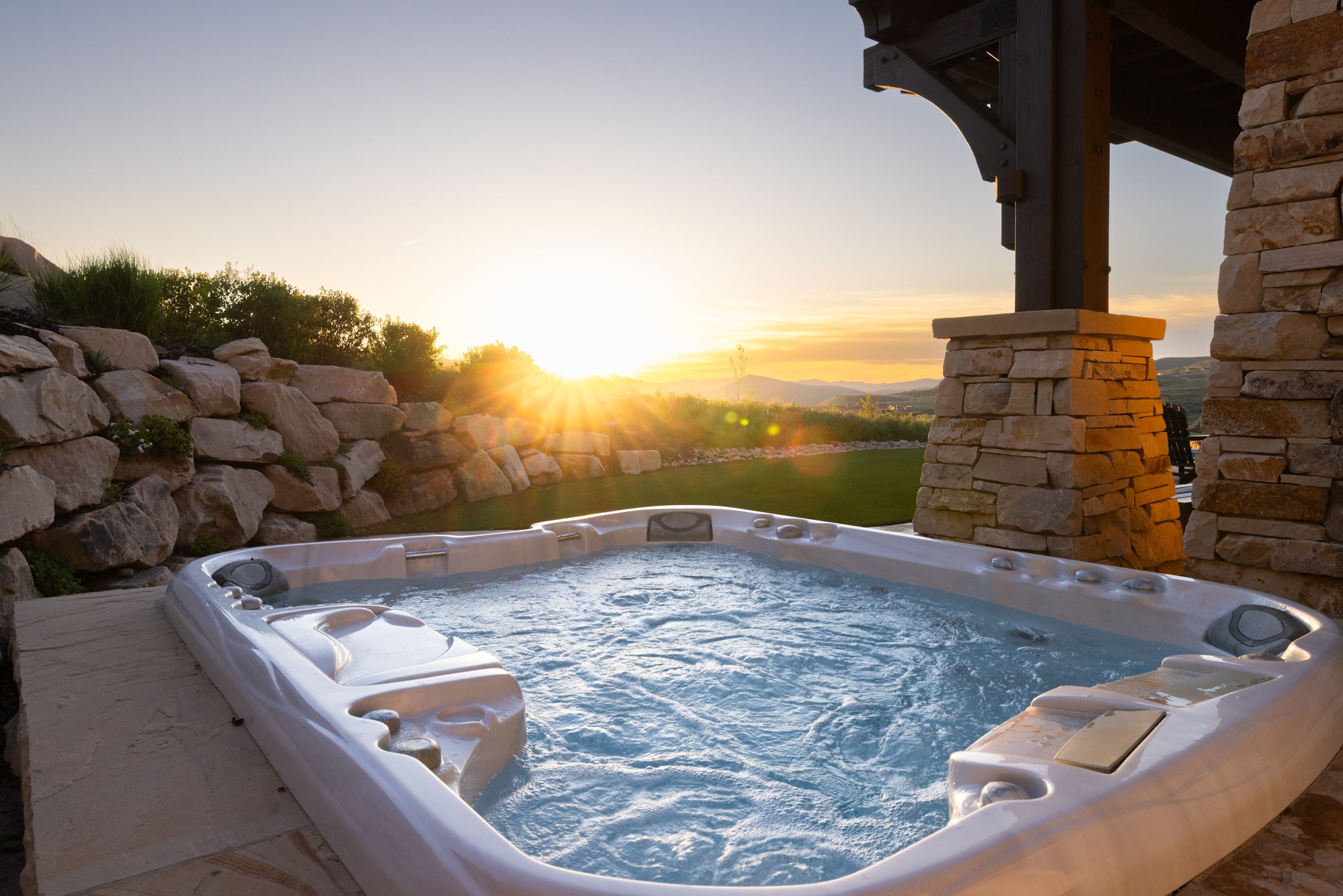 Outdoor spa with bubbling water, set on a stone patio