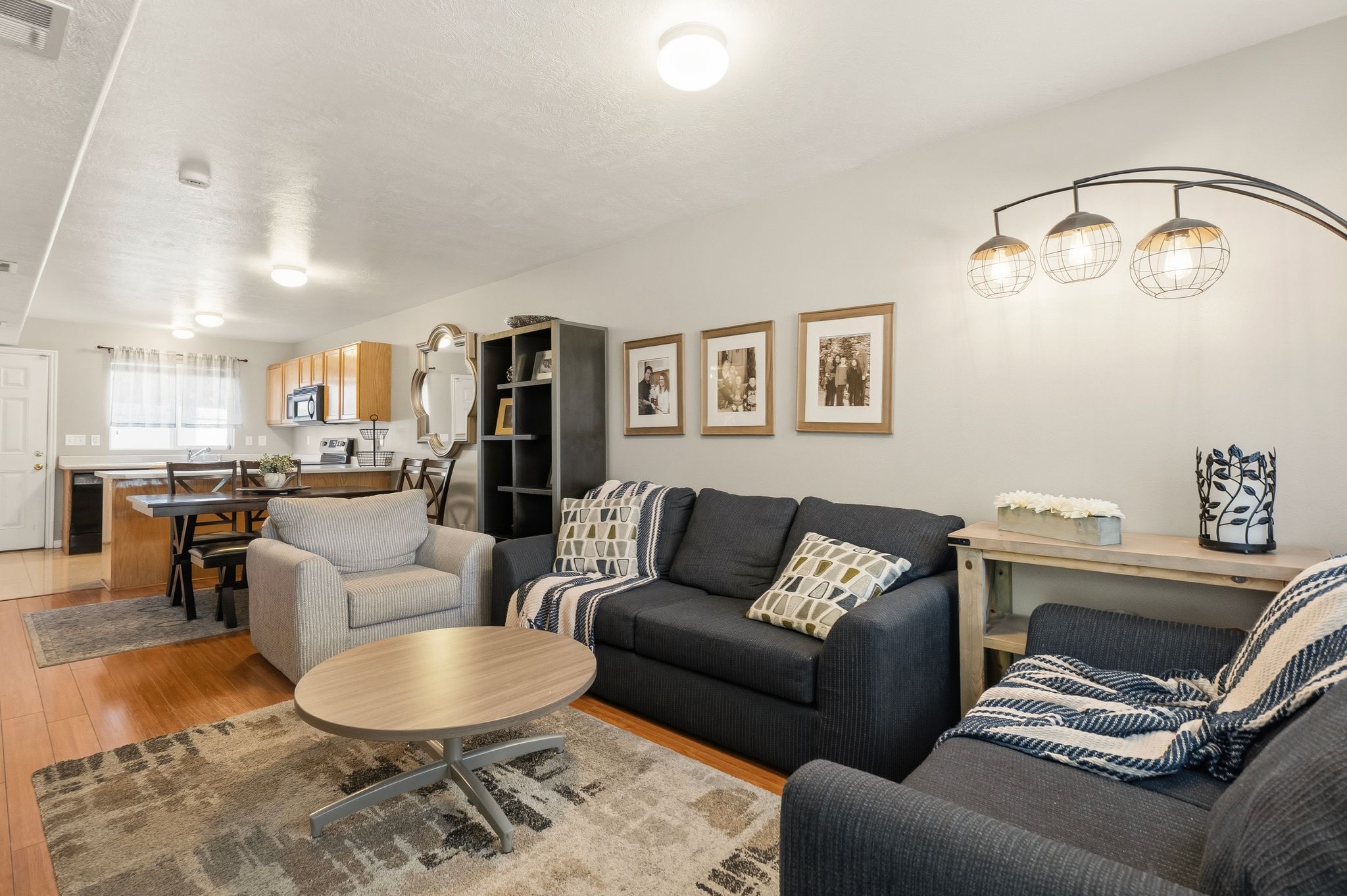 Open-concept living area featuring wood-finish flooring, recessed lighting, and light-toned wall paint