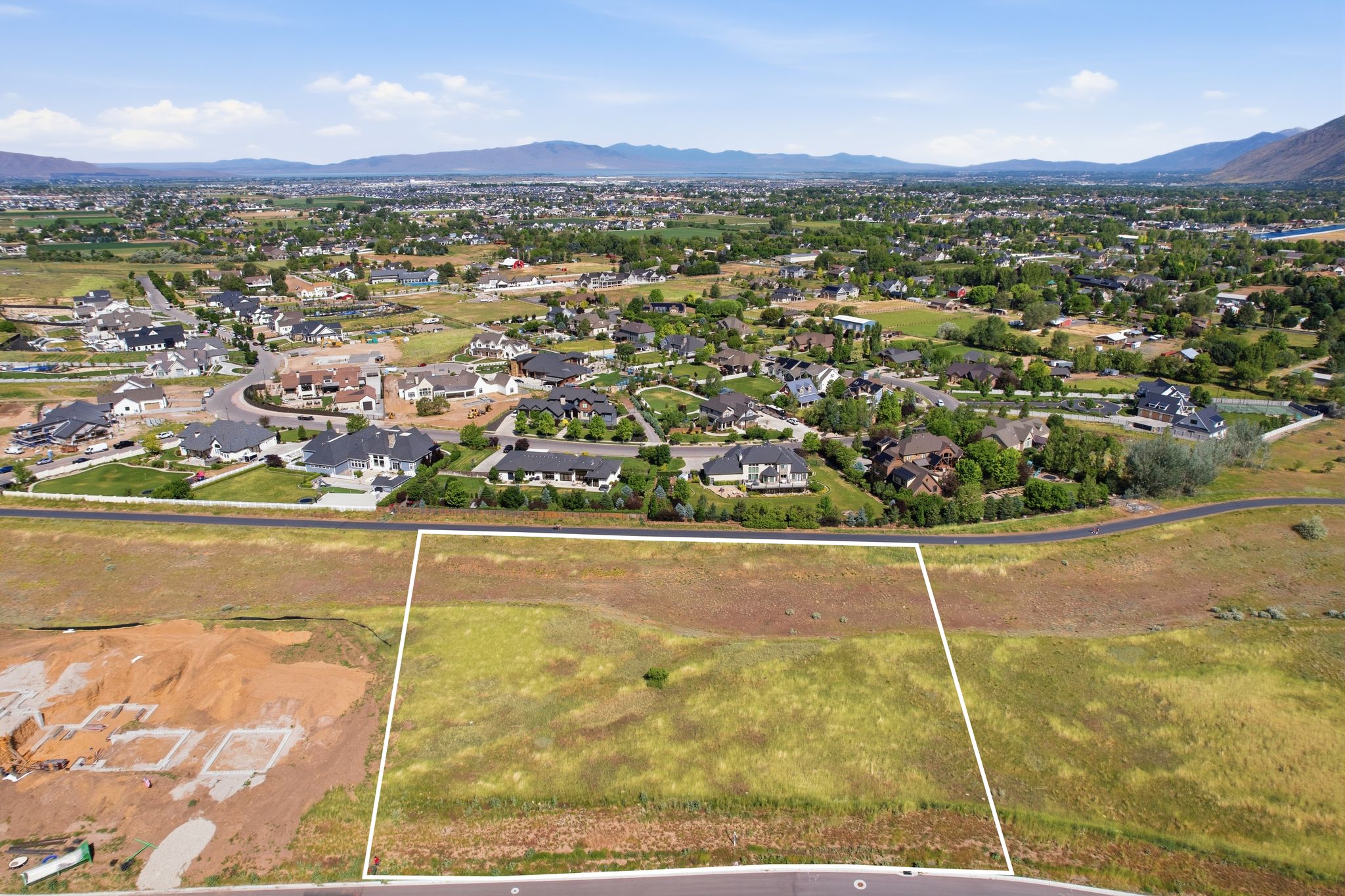 Expansive land parcel outlined with a white border, featuring natural ground cover