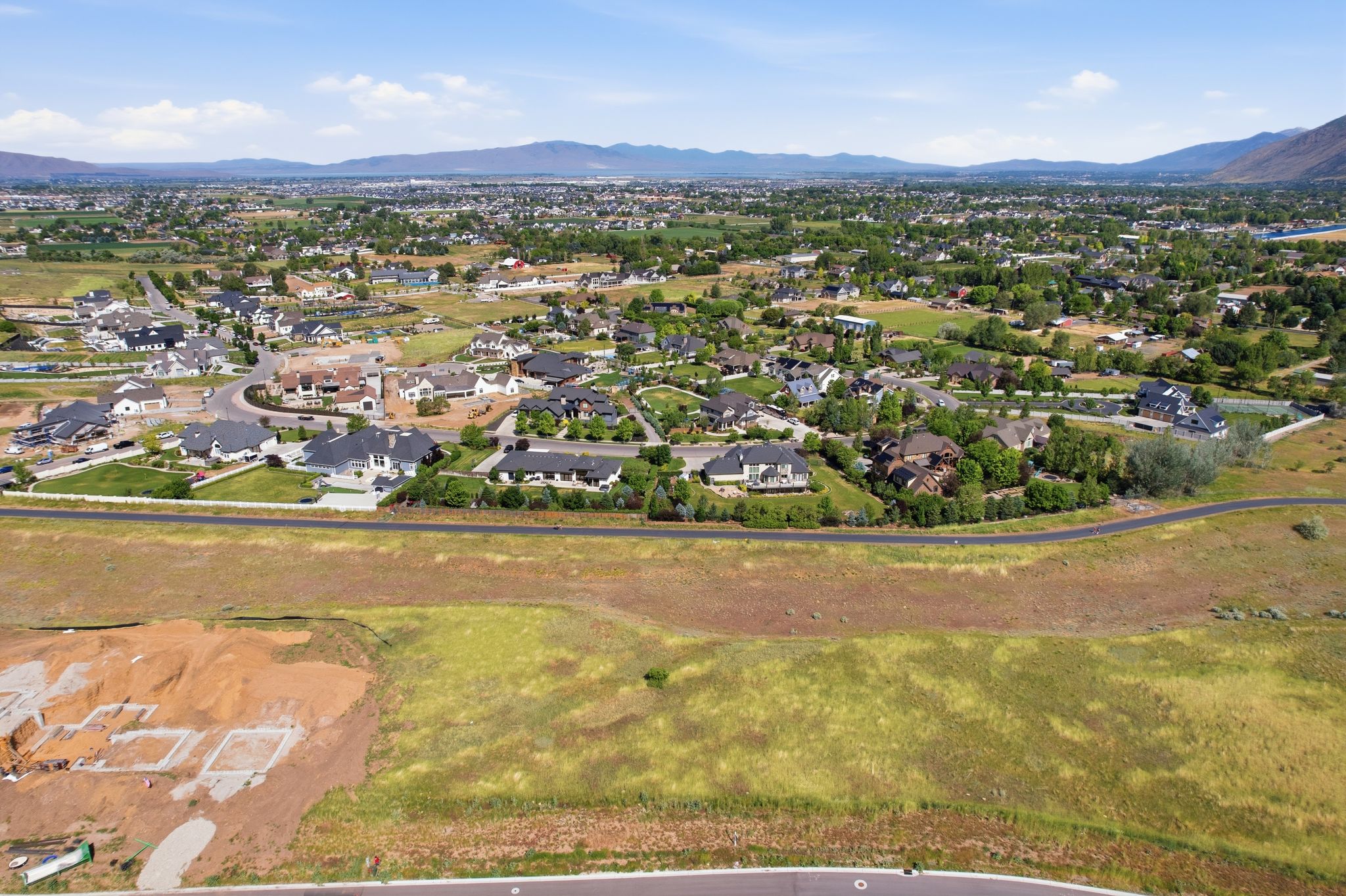 Expansive community showcasing a variety of architectural styles, mature landscaping, and mountain backdrops