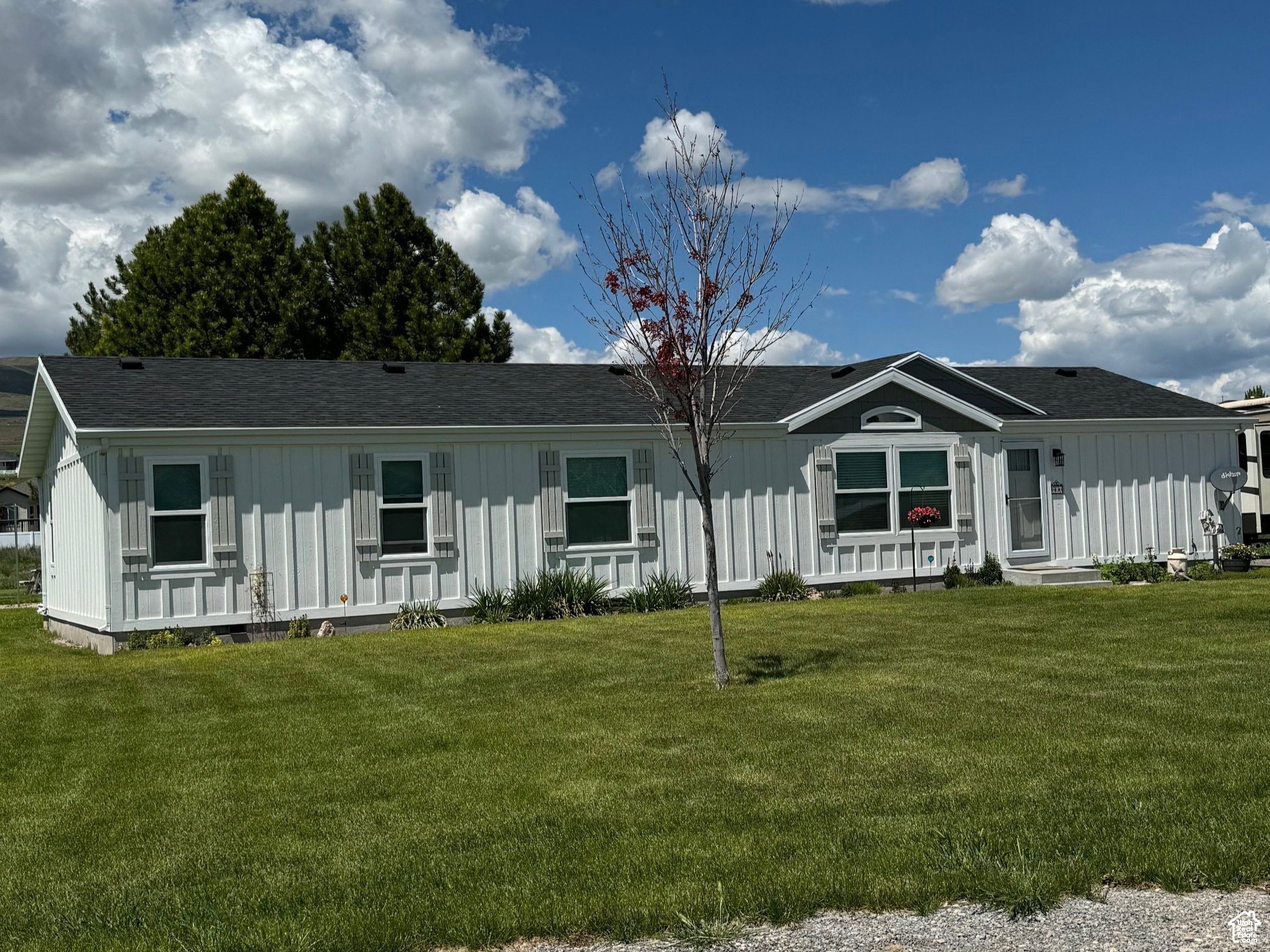 Single-story residence featuring white board-and-batten style siding