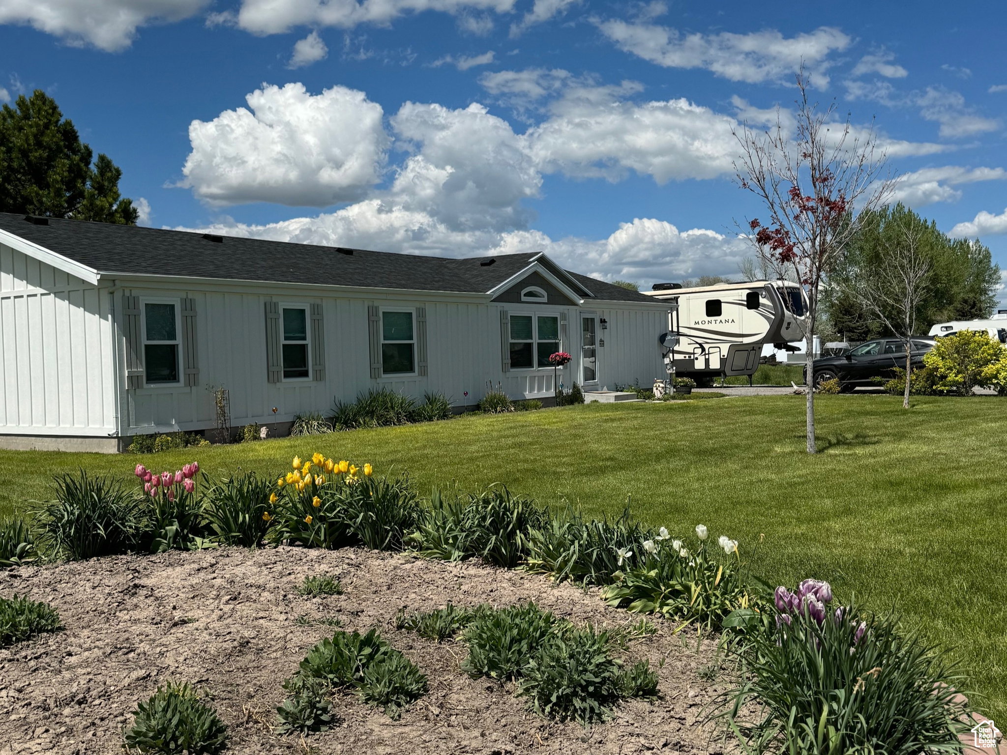 White exterior siding with dark shingle roofing