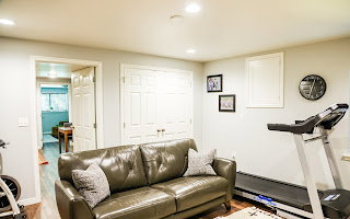 Spacious room featuring recessed lighting, wood-finish flooring, light neutral wall paint, and white trim