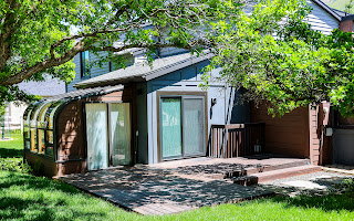Beautiful Sun room  Wood-look deck with tiered steps, providing outdoor living space