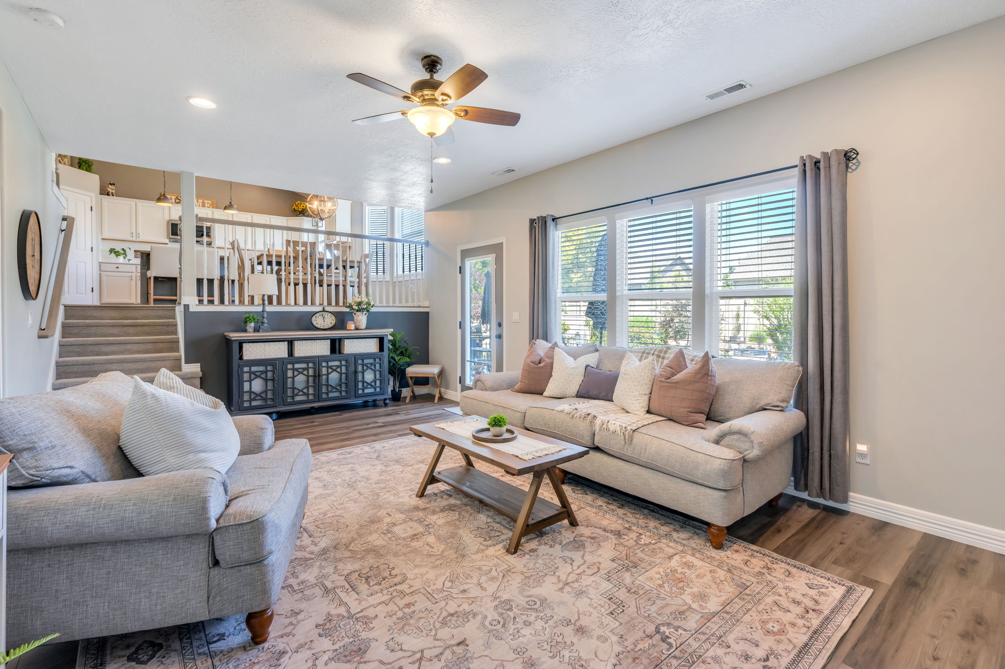 Living area featuring wood-finish flooring, recessed lighting, and a ceiling fan