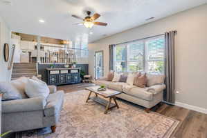 Living area featuring wood-finish flooring, recessed lighting, and a ceiling fan